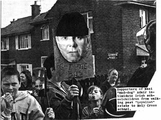 Supporters if Irish "Mad dag" Adair intimiadate Irish schoolchildren walking to Holy Cross school